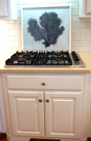 The sea fan artwork behind the gas cooktop washes clean easily.